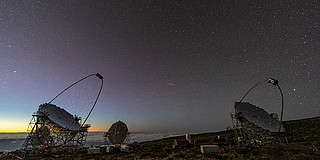 Telescopes on La Palma, with a starry sky in the background