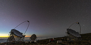 Telescopes on La Palma, with a starry sky in the background