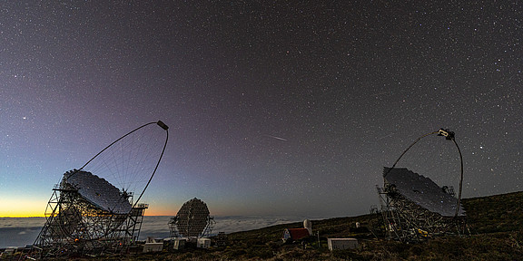 Telescopes on La Palma, with a starry sky in the background