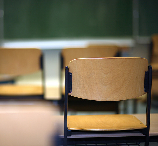Chairs placed on tables in a classroom