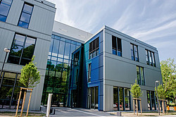 Photo: A modern building with a large glass façade at the entrance.