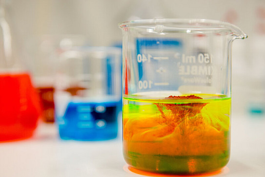 A photo of three test tubes containing colorful liquids.