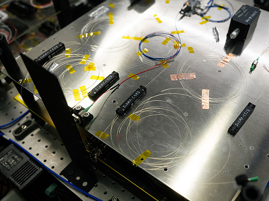 Photo of a metal plate with glass fibers glued to it.