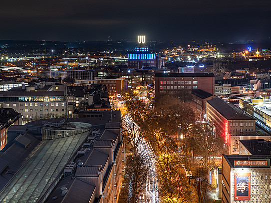 Nighttime shot of downtown Dortmund, including the opera house and the U