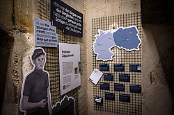 Photo: An exhibition corner with text panels, quotes, and a map about forced labor in mining during the Nazi era.