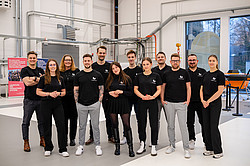 Group photo: GEMESYS employees posing in black clothing.